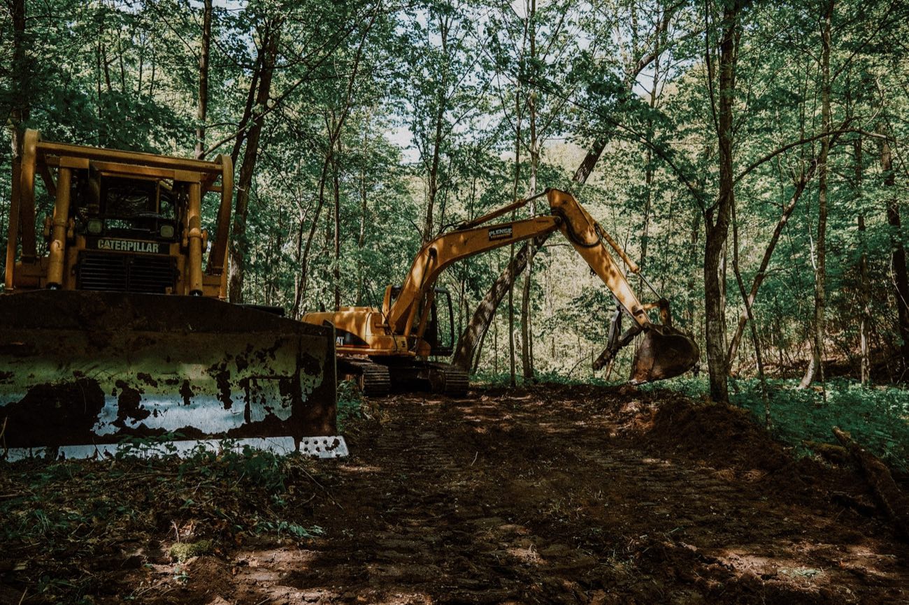 Plenge Excavation CAT dozer and excavator clearing wooded land